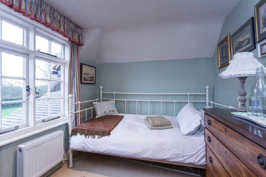 Bay window overlooking pond with daffodils