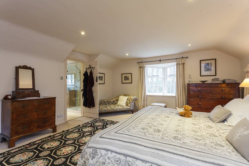 Farthing Corner bedroom with period features and warm lighting